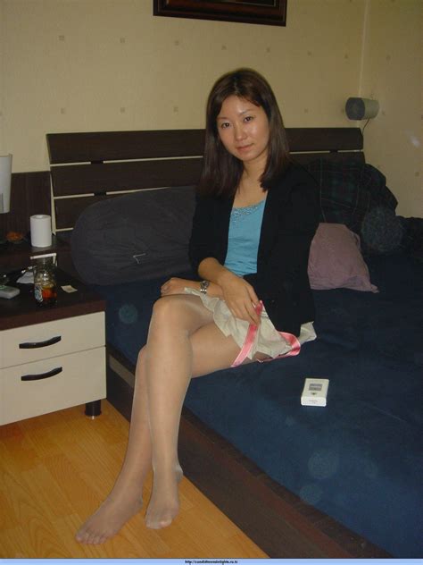 asian babe with legs crossed while wearing pantyhose and no shoes pantyhose with nylon feet