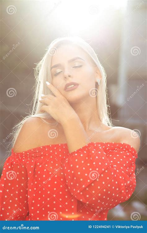Stylish Blonde Model With Naked Shoulders In Red Dress Posing O Stock