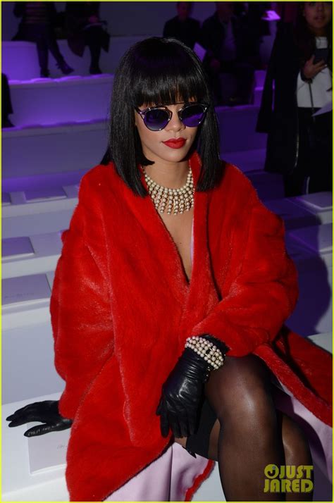 rihanna covers up her sexy black dress with red coat at