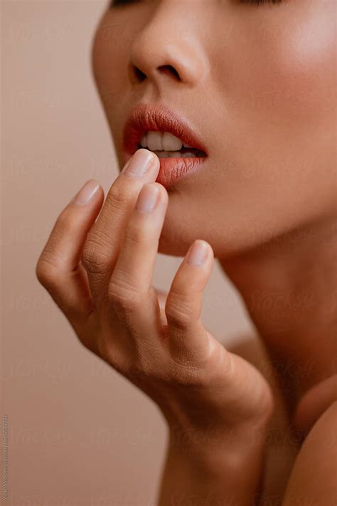 Beauty Portrait Of A Woman Touching Her Lip By Stocksy Contributor
