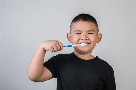 boy brushing  teeth  studio photo  stock photo
