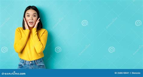 Portrait Of Surprised Asian Girl Checking Out Promo Gasping Amazed And