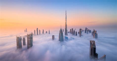 photographer captures skyscrapers  dubai rising   clouds petapixel