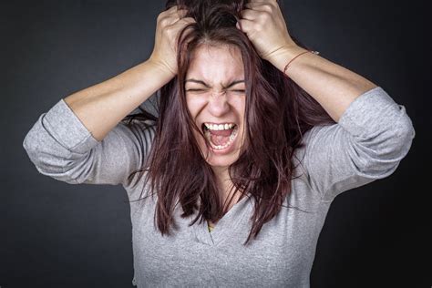 frustrated angry woman screaming  pulling  hair young woman