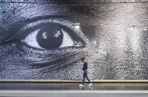 street artist jr takes   paris metro   giant posters