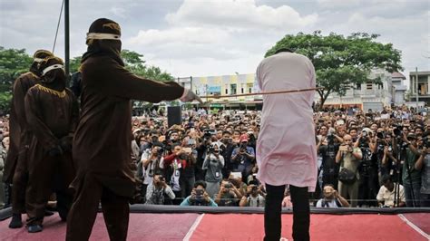 reporter describes watching gay indonesian couple being caned in front