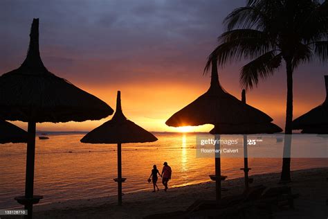 Romantic Stroll At Sunset On Tropical Beach High Res Stock