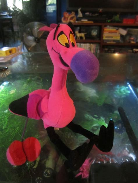 pink stuffed animal sitting  top   glass table    fish tank