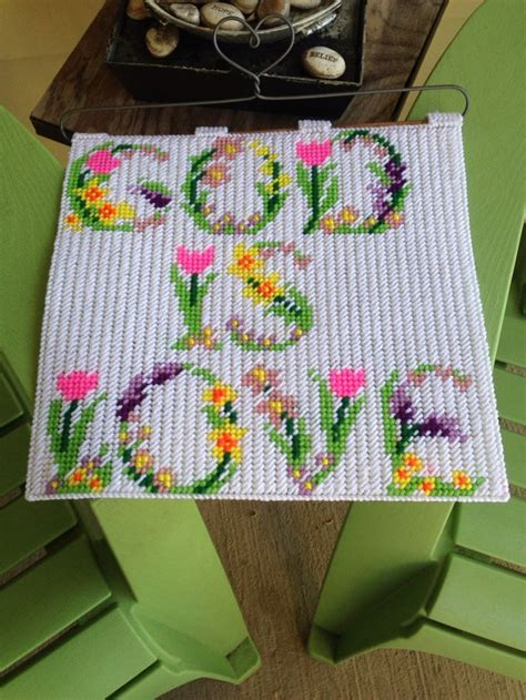 god is love made from a cross stitch pattern into a plastic canvas