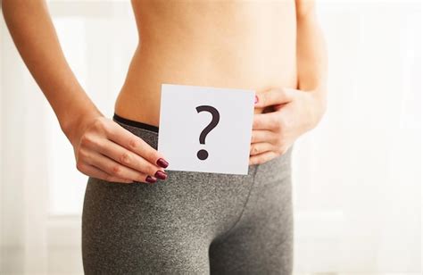 Premium Photo Woman Body In Underwear With Question Card Near Belly