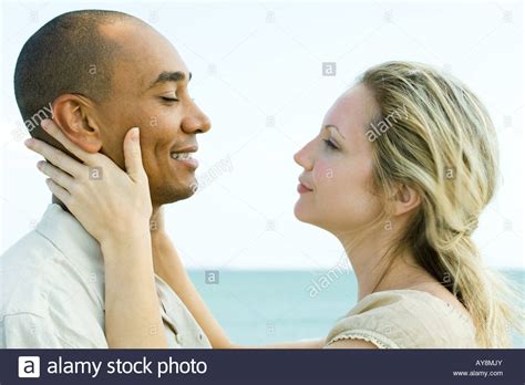 Couple Face To Face Woman Holding Man S Neck Side View