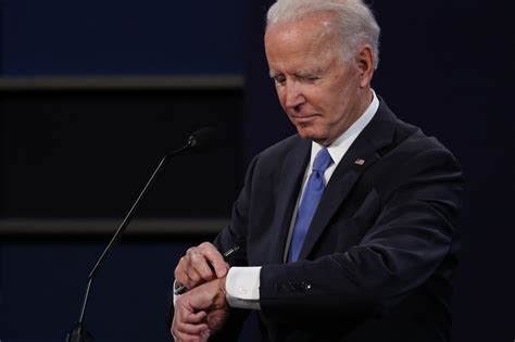 biden checks watch to see how much time remains in debate