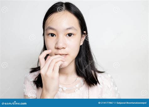 worried asian teen girl bites fingernails risk of germs bacterial