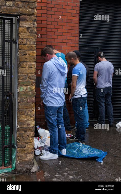 Male Revellers Urinate In Public In A Street At Notting Hill Carnival
