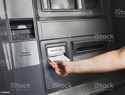 hand places deposit envelope  slot  atm stock photo  image  istock