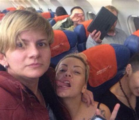lesbian couple sat by anti gay russian politician pose for selfie kissing in front of him