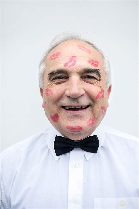 Portrait Of An Old Man With Red Lip Print On His Face By Stocksy