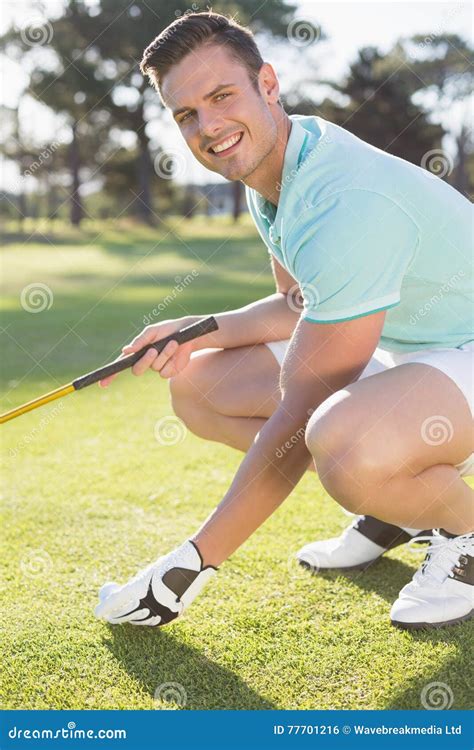 portrait  confident golfer man placing golf ball  tee stock photo