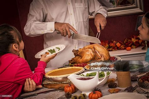 young father carving thanksgiving turkey   family high res stock photo getty images