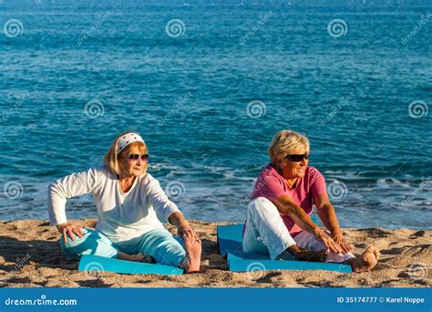 golden age ladies stretching  beach stock image image