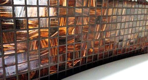 beautiful copper colored tile back splash in the kitchen