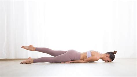 woman practicing yoga salabhasana locust pose yoga  props yoga
