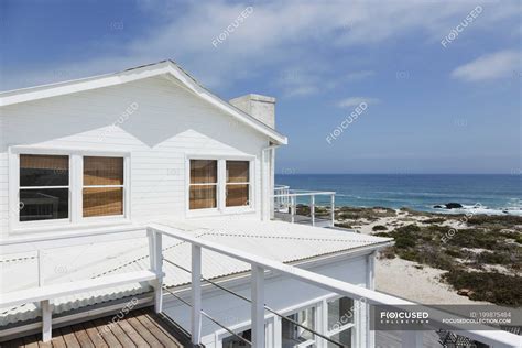 facade  beach house overlooking ocean railing copy space stock