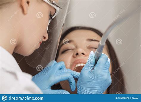 dentist doing a dental treatment on a female patient