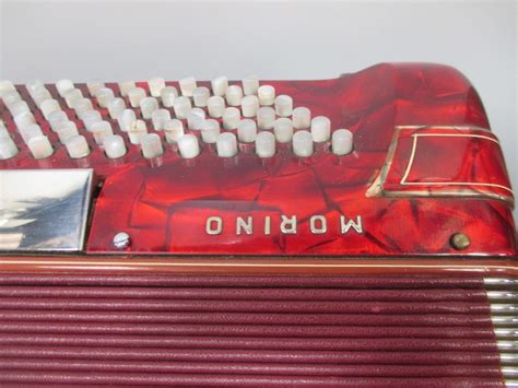 A Hohner Shand Morino 46 Button Accordion Together With Hohner Hard