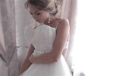 beautiful bride in lingerie tries on a wedding dress by alex eg videohive