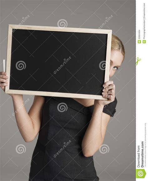Female Teacher Peeking From Behind Blackboard Stock Images
