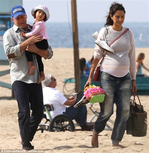 bruce willis plays on the beach with his one year old daughter mabel and pregnant wife emma