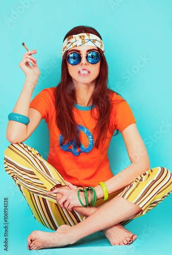 beautiful hippy girl portrait sitting and smoking weed buy this stock