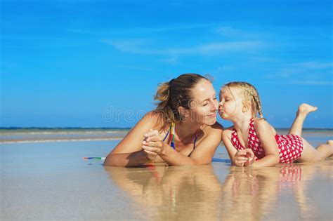 Cute Girl Kissing Happy Smiling Mother On Sea Beach Stock