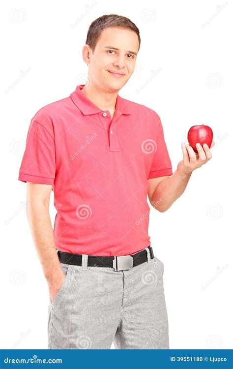 casual young man holding  apple stock photo image  casual posing