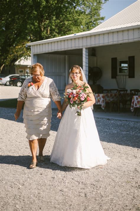 Bride And Mom Walking Down The Aisle From A Boho Barn Wedding In