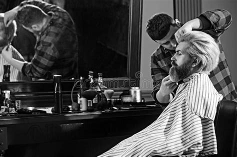 bearded man in barbershop barber that steam your face with hot water