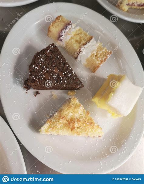 selection of cakes chocolate brownie victoria sponge cake custard slice and raspberry and
