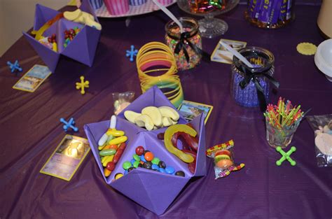 a purple table topped with lots of candy and candies