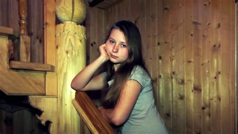 Nice Teen Girl Stands And Smiles Leaning On Railing Carved