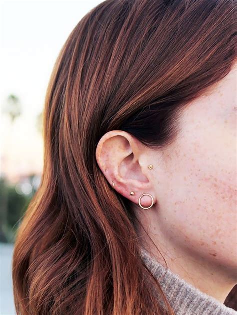 cool girl ear piercings  discovered  pinterest byrdie