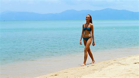 Cute And Sexy Woman In Bikini Walking On The Beach By Daniel Dash