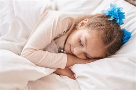 Adorable Caucasian Girl Lying On Bed Sleeping At Bedroom Stock Image