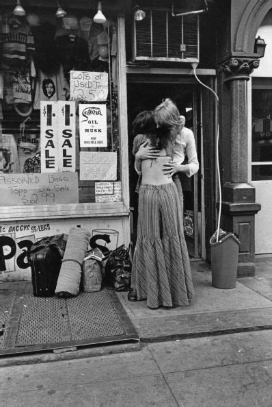 a hippie couple embrace outside a shop selling second hand clothes in st mark s place new york