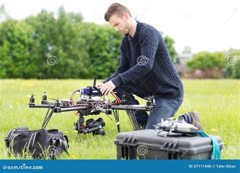 engineer preparing surveillance drone  park stock photo image  futuristic control