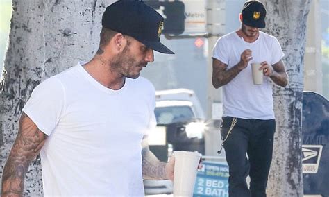 david beckham goes for a youthful green sneakers and chain as he grabs