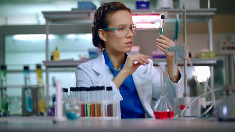 female chemist  laboratory chemist analyzing chemical liquid  test tube woman chemist