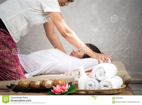 thai masseuse doing massage for woman in spa salon asian