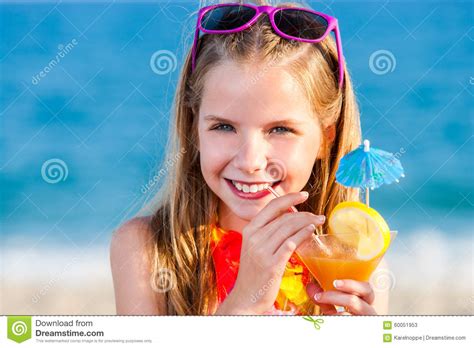 cute girl drinking fruit cocktail on beach stock image