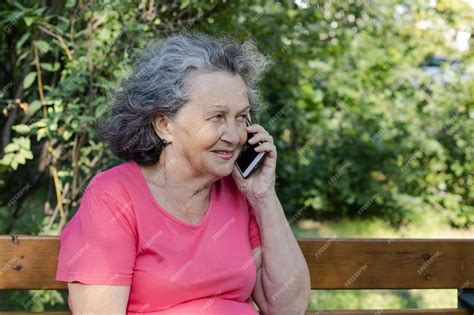 Premium Photo An Elderly Woman With Gray Hair Is Talking On The Phone